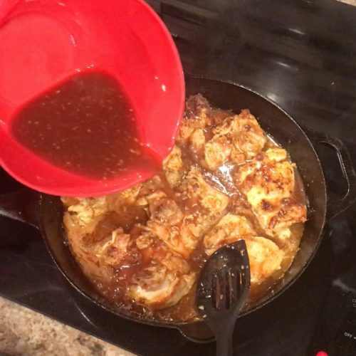 Pouring Coca Cola Sauce over chicken