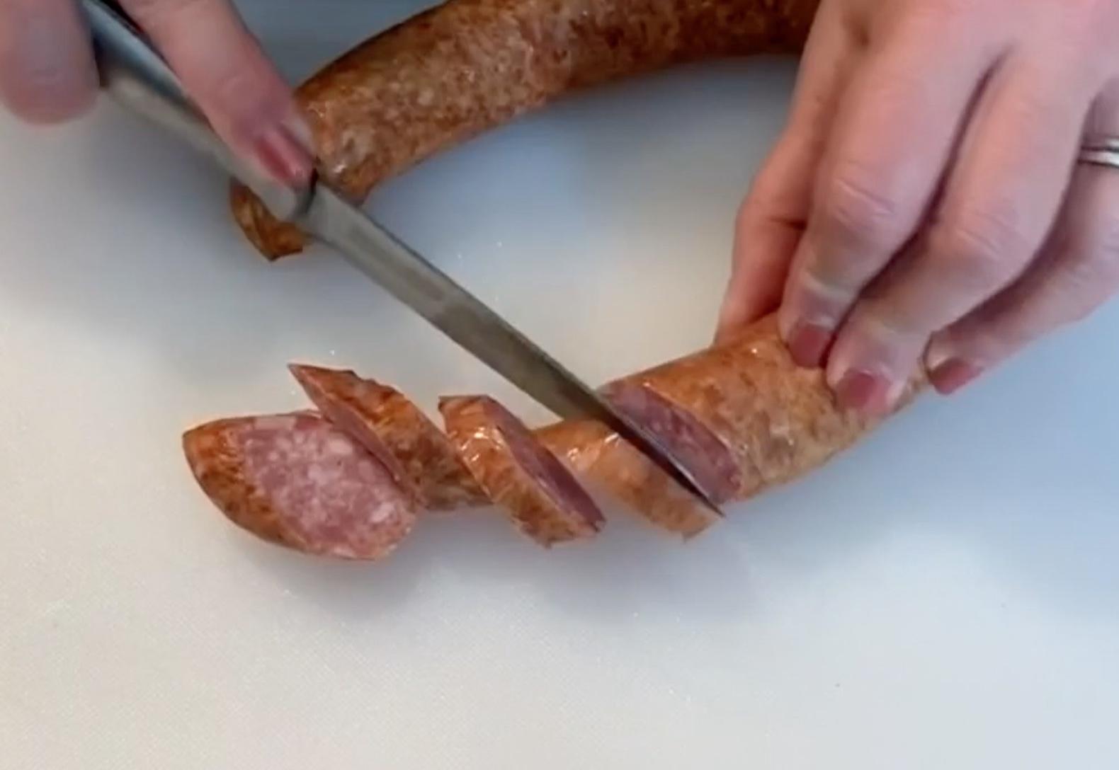 Slicing Smoked Sausage on cutting board
