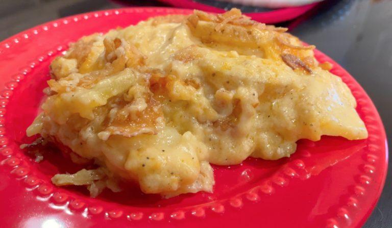 cheesy scalloped potato on red plate