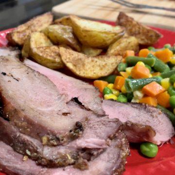 Grilled Sirloin Tip Roast on red plate