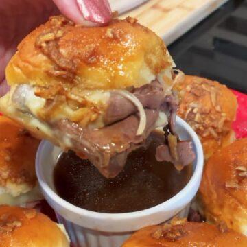 French Dips on a plate dipping into Au jus