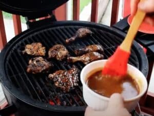 Jamaican Jerk Chicken Basting on the grill